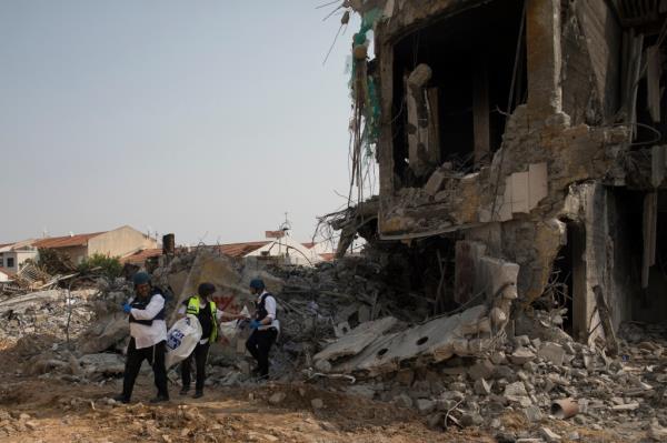 Israeli rescue members work at a police station that was destroyed after a battle between Israeli troops and Hamas militants on Oct. 8, 2023 in Sderot, Israel.