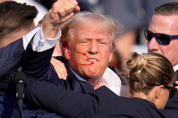 Trump seen with blood on his face following an assassination attempt at a campaign event in Butler, Pa., on July 13.