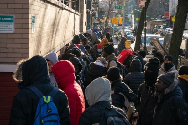Migrants line up outside a migrant re-ticketing center at St. Brigid School on E. 7th St. on Jan. 5, 2024, in Manhattan. (Barry Williams for New York Daily News)