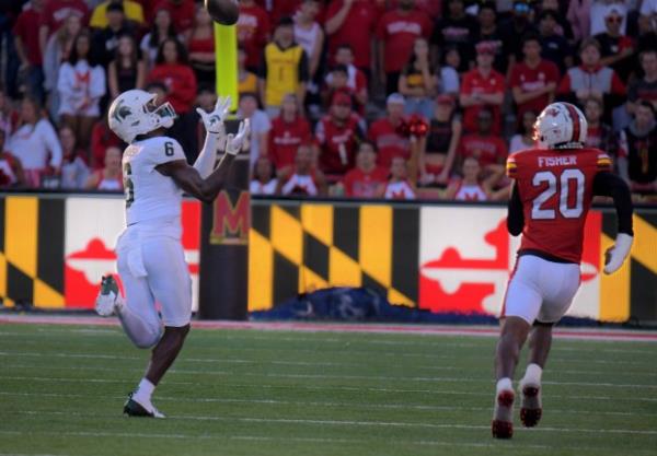 Michigan State Spartans wide receiver Nick Marsh looks a deep pass into his hands for a touchdown to tie the game as Maryland Terrapins defensive back Perry Fisher pursues during the first Big Ten game of the season in College Park. Michigan State upset the Terrapins, 27-24. (Karl Merton Ferron/Staff)